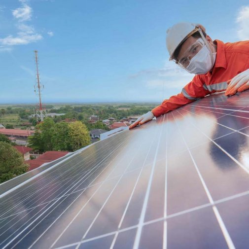 Ein Mann der eine Photovoltaikanlage montiert